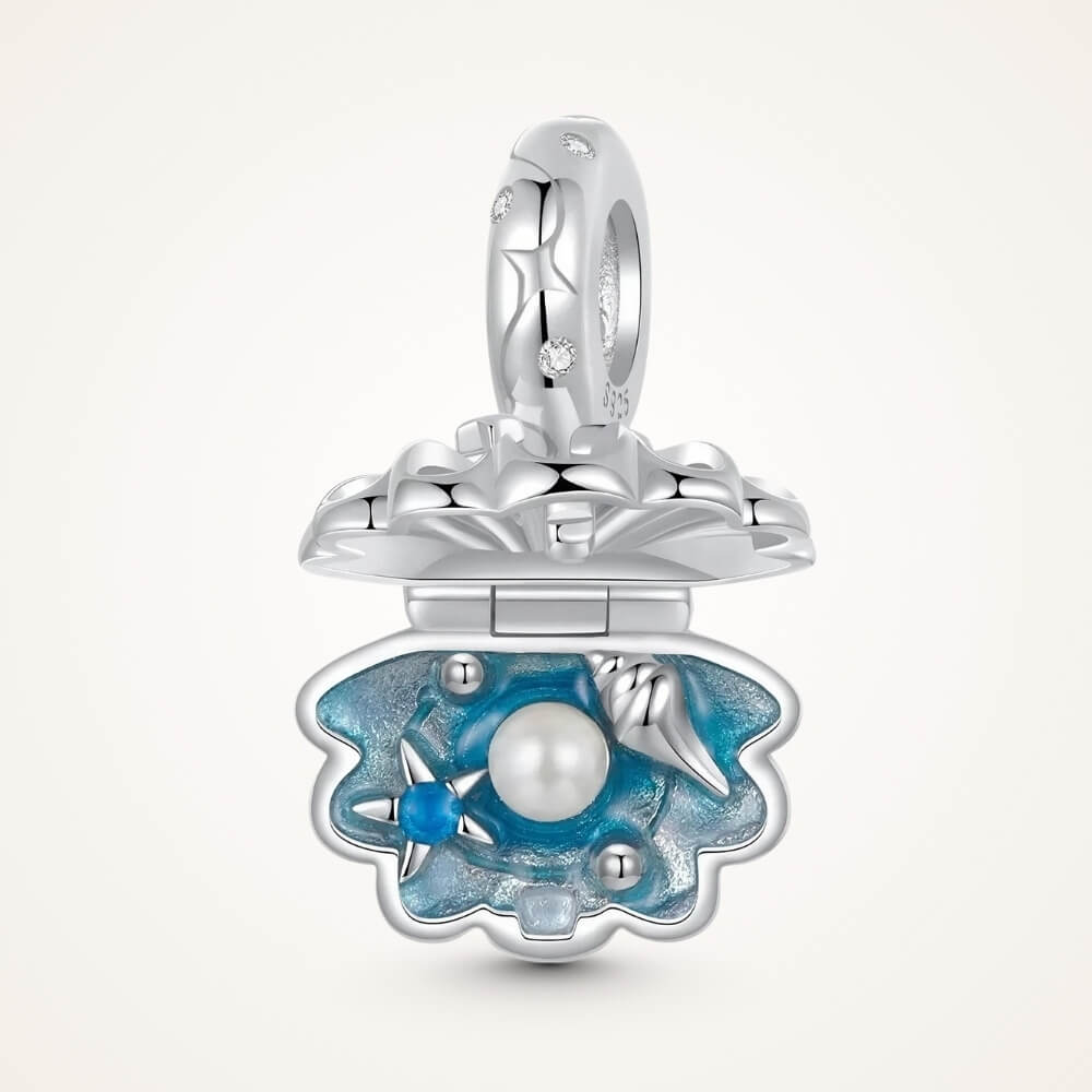 Sterling silver shell charm with hidden pearl and ocean blue enamel.