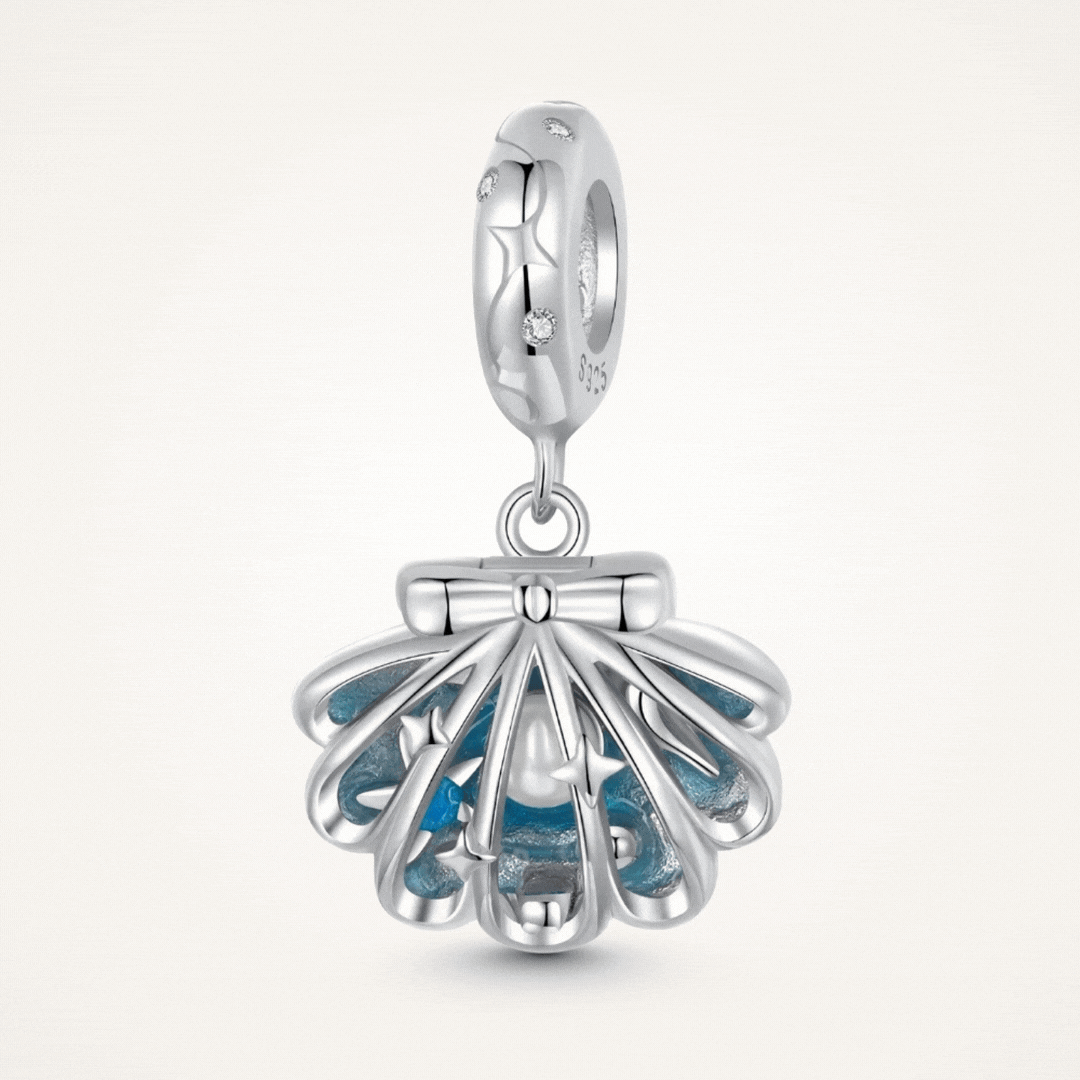 Sterling silver shell charm with hidden pearl and ocean blue enamel.