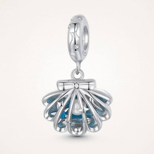 Sterling silver shell charm with hidden pearl and ocean blue enamel.
