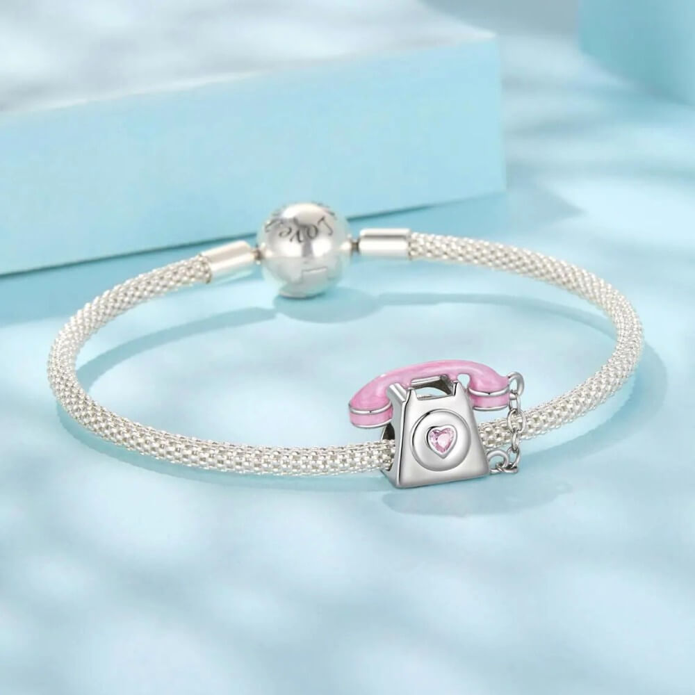 Sterling silver phone charm with heart detail and polished finish.
