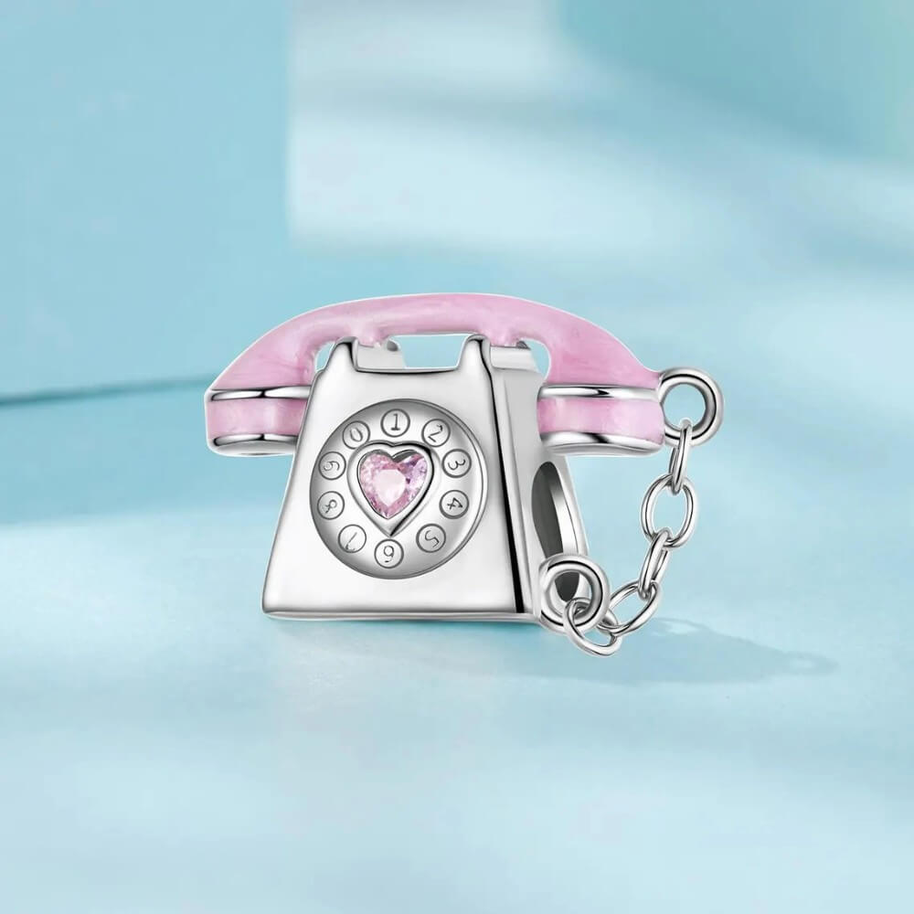 Sterling silver phone charm with heart detail and polished finish.
