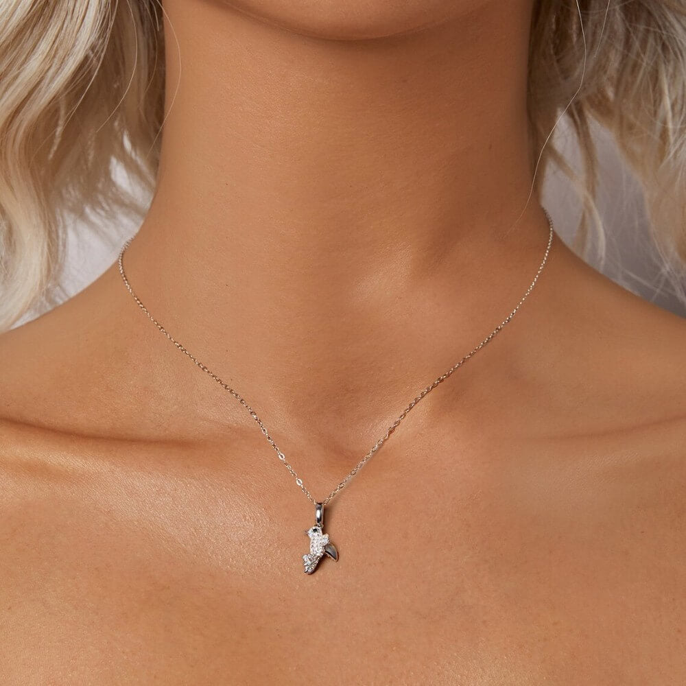Sterling silver hummingbird charm with blue opal stones and crystal details.