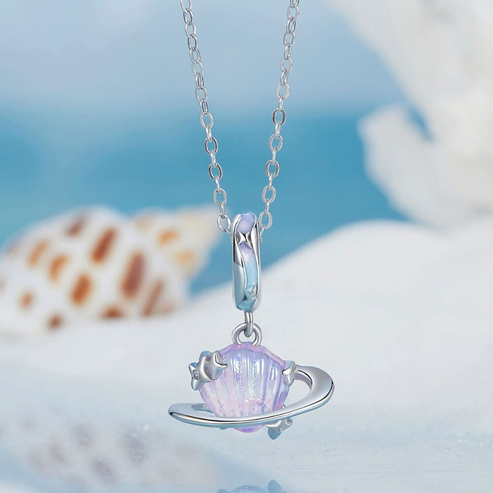 Sterling silver planet charm with iridescent shell design and star accents.