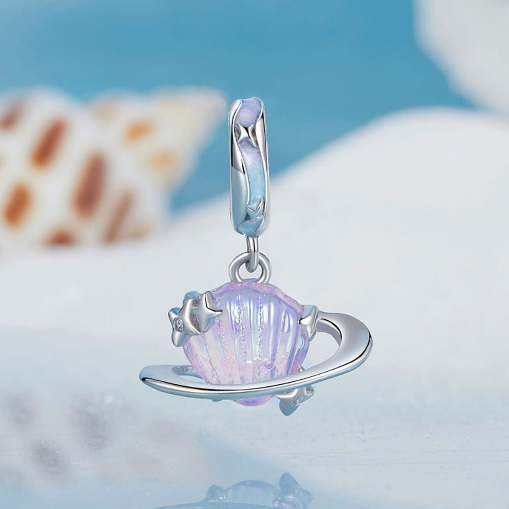 Sterling silver planet charm with iridescent shell design and star accents.