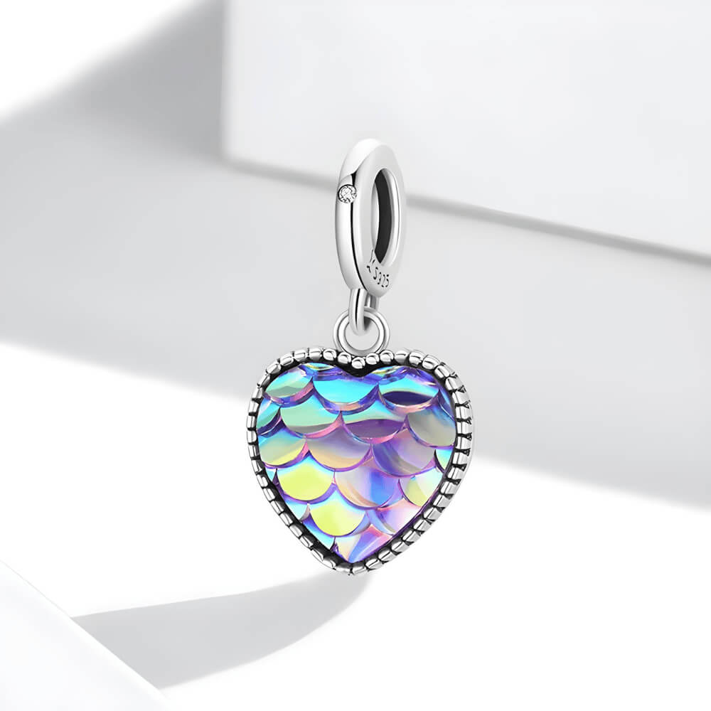 Sterling silver heart charm with iridescent scale-patterned resin front and beaded border.