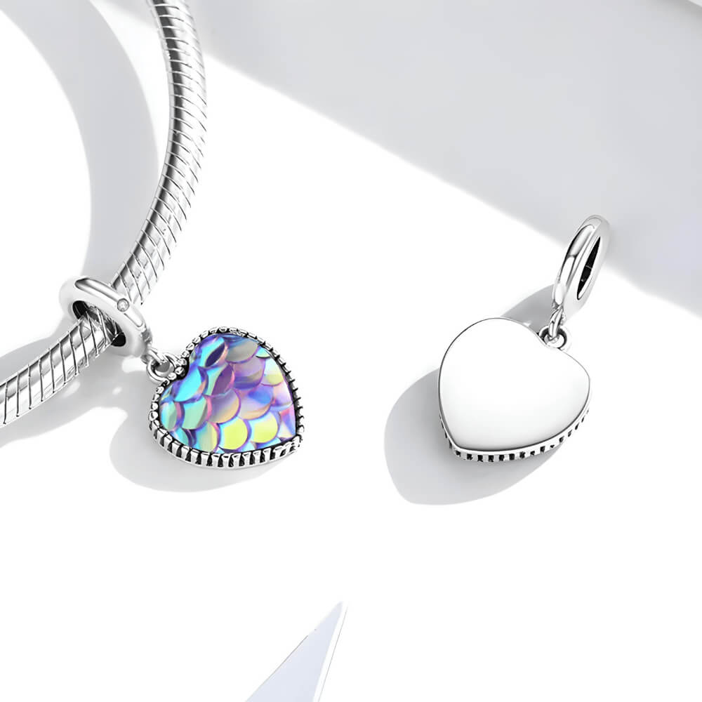 Sterling silver heart charm with iridescent scale-patterned resin front and beaded border.