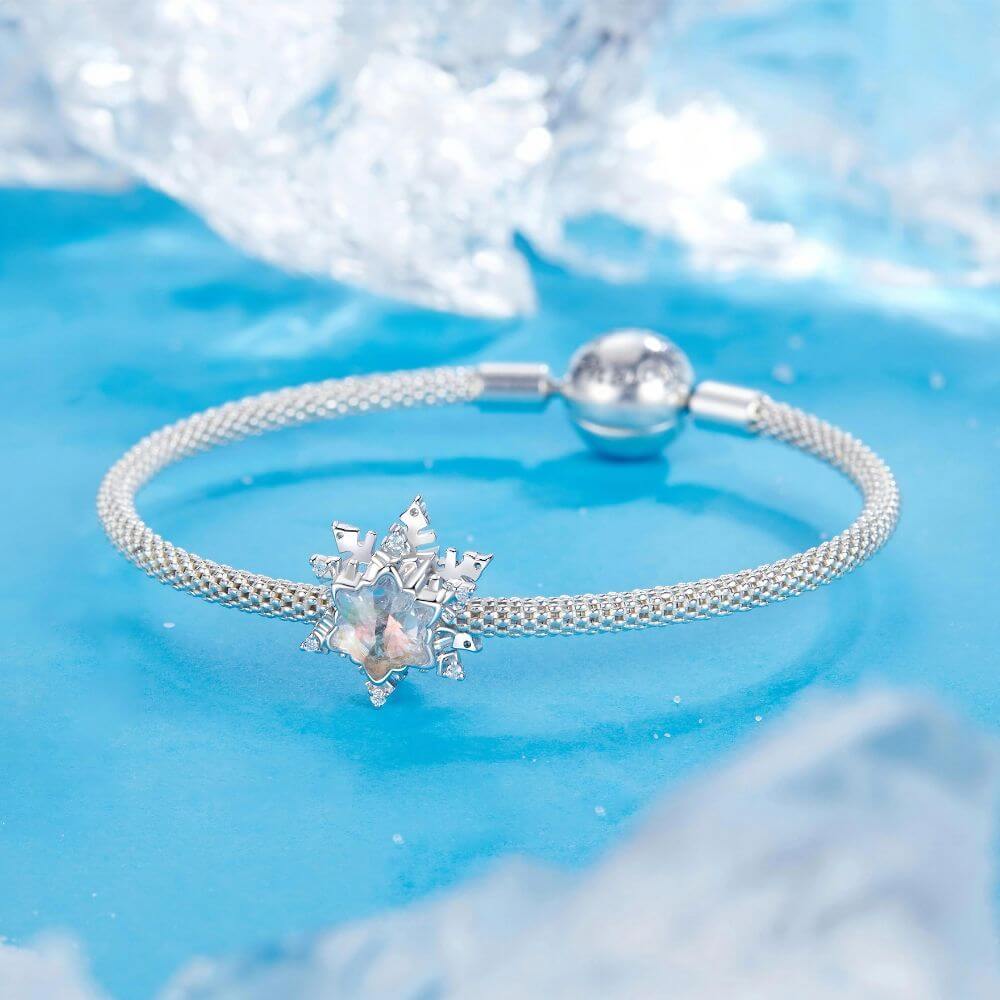 Sterling silver snowflake charm with iridescent crystal center and sparkling clear crystal accents.