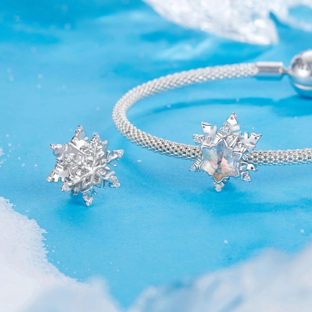 Sterling silver snowflake charm with iridescent crystal center and sparkling clear crystal accents.