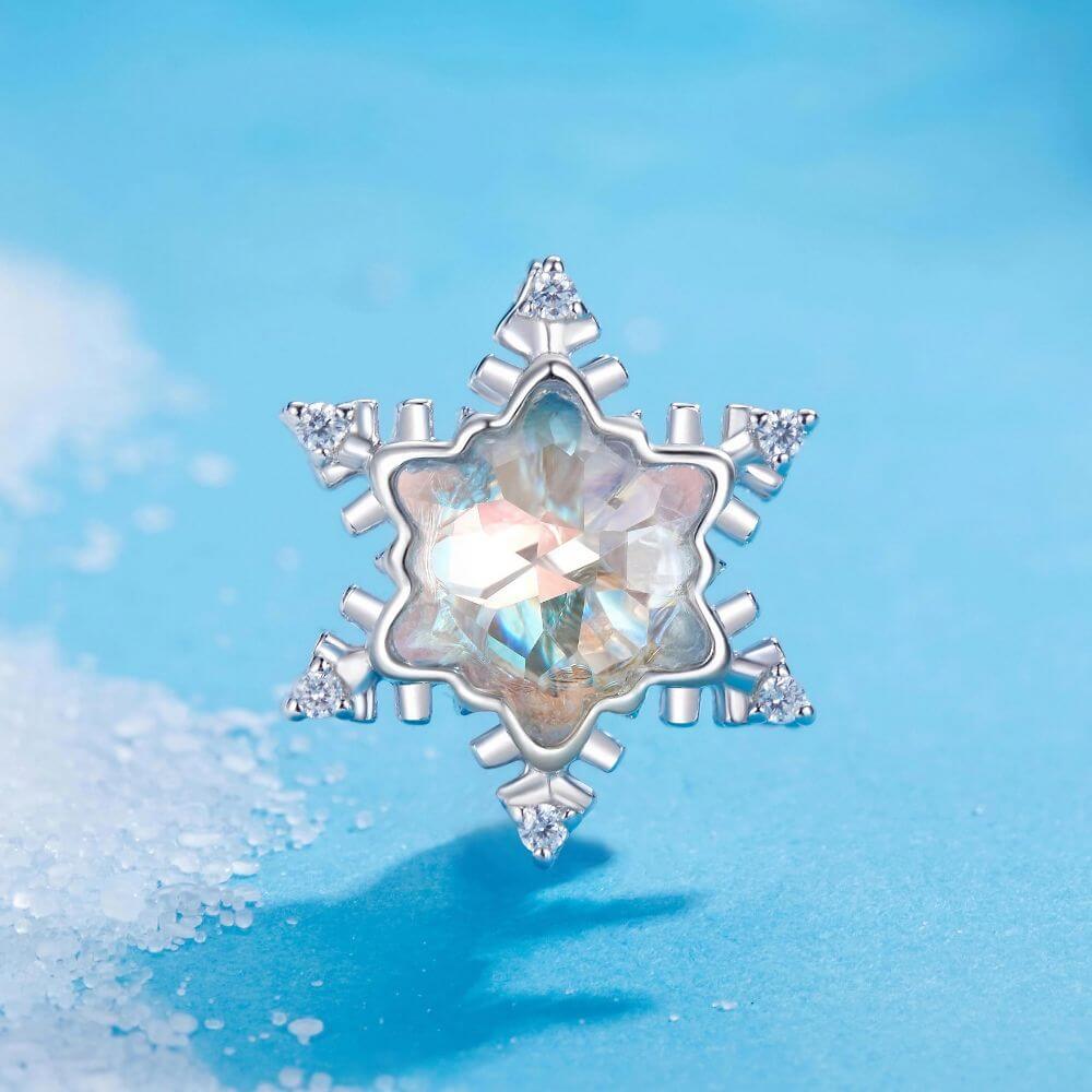 Sterling silver snowflake charm with iridescent crystal center and sparkling clear crystal accents.