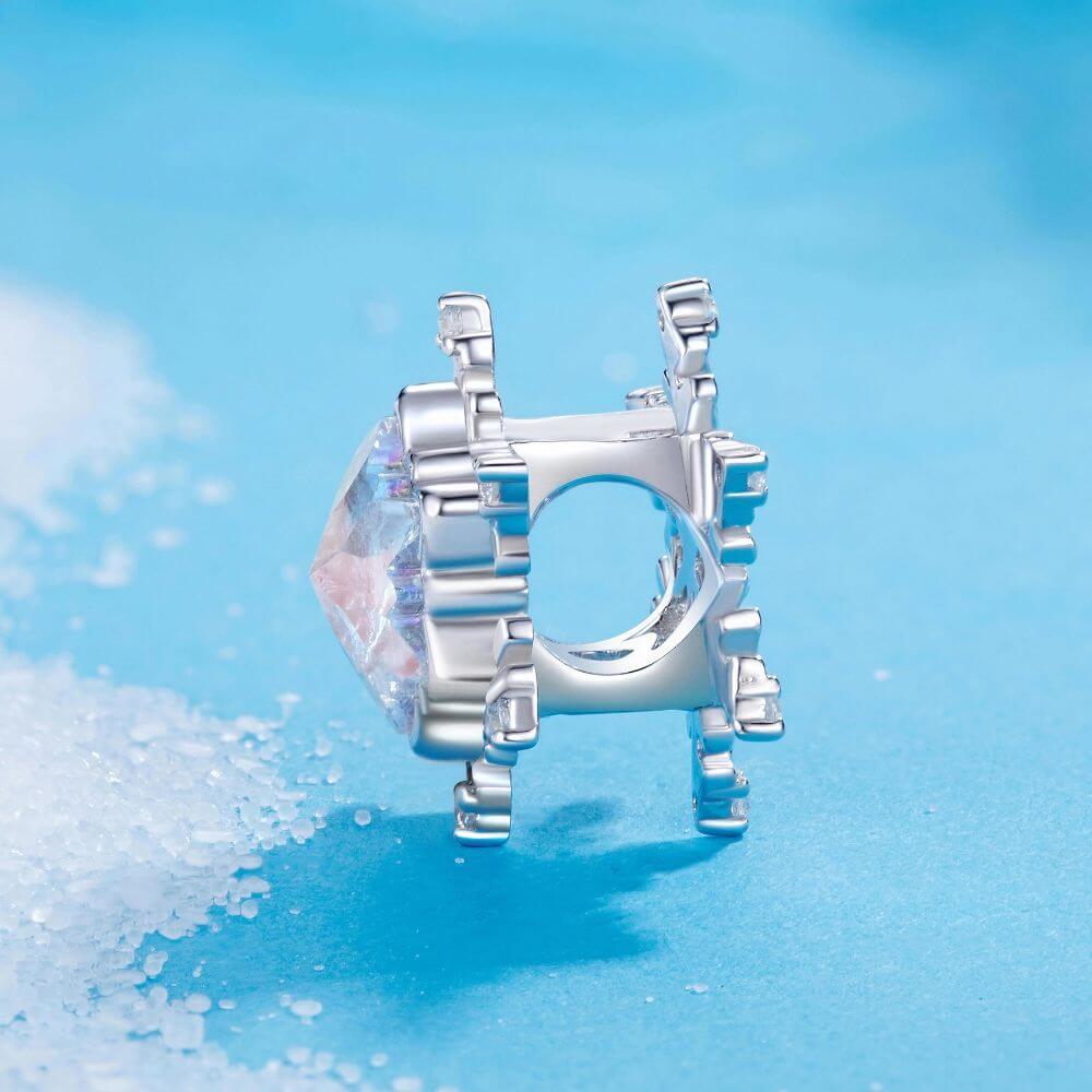 Sterling silver snowflake charm with iridescent crystal center and sparkling clear crystal accents.