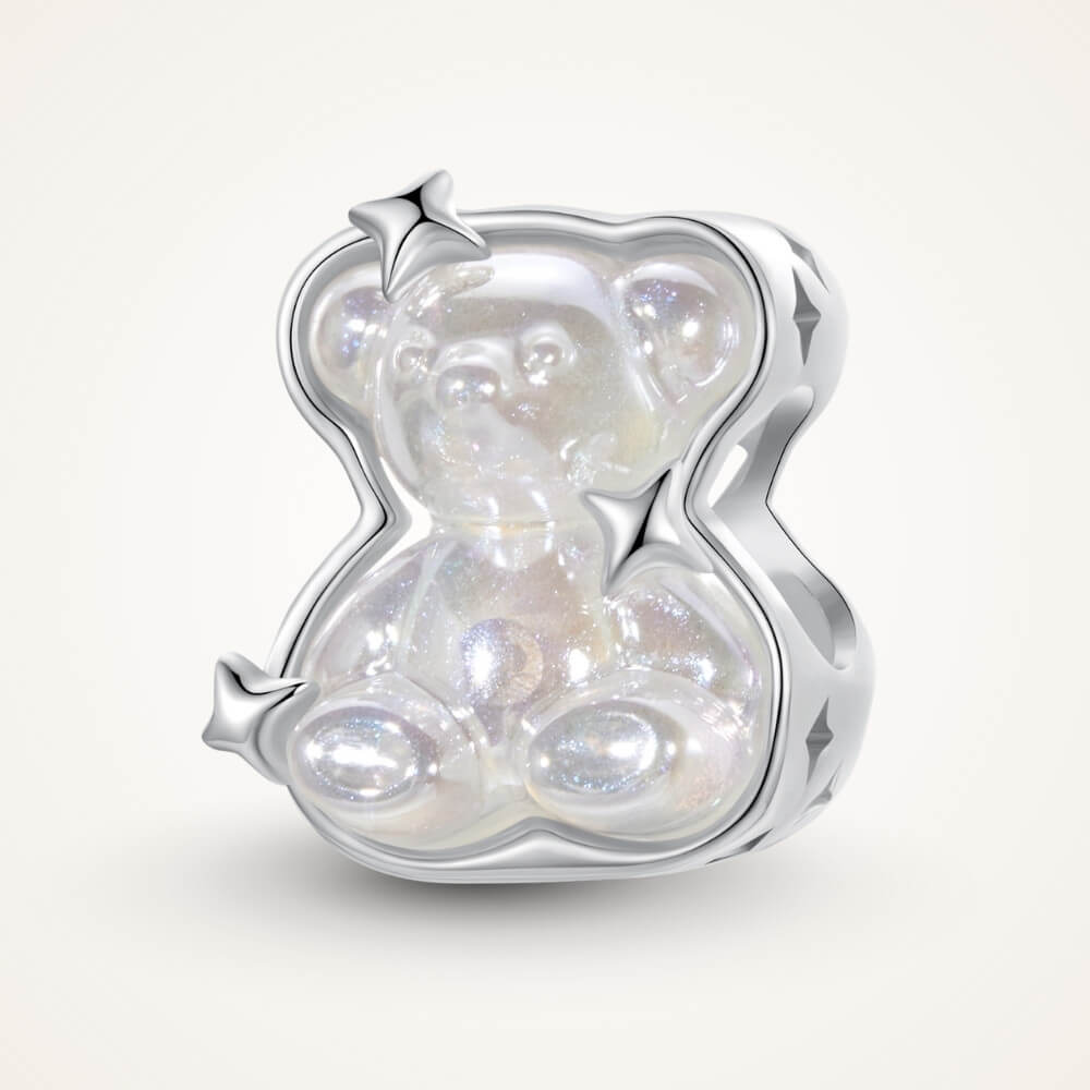 Sterling silver teddy bear charm with iridescent finish and star details.
