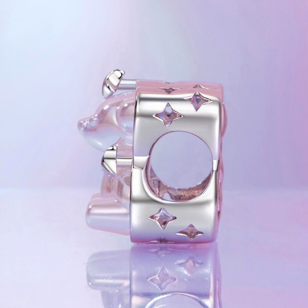Sterling silver teddy bear charm with iridescent finish and star details.