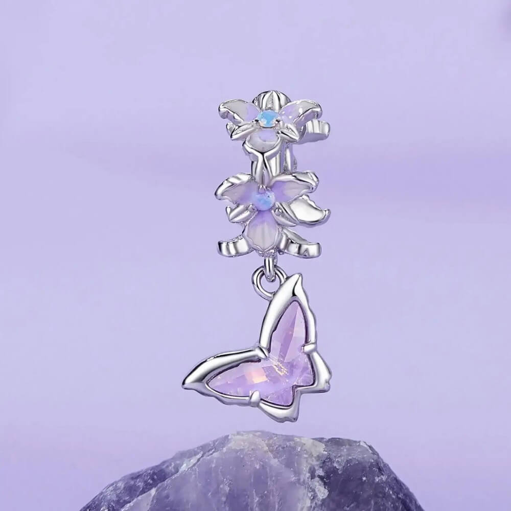 Sterling silver butterfly charm with lavender crystal and floral details.