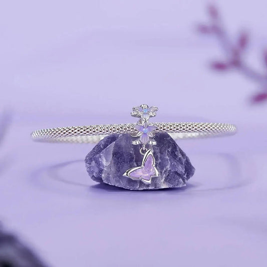 Sterling silver butterfly charm with lavender crystal and floral details.