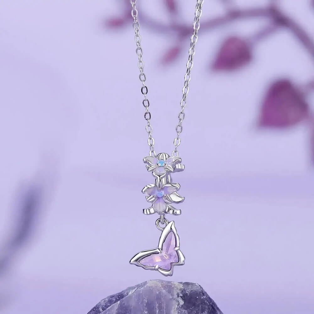 Sterling silver butterfly charm with lavender crystal and floral details.
