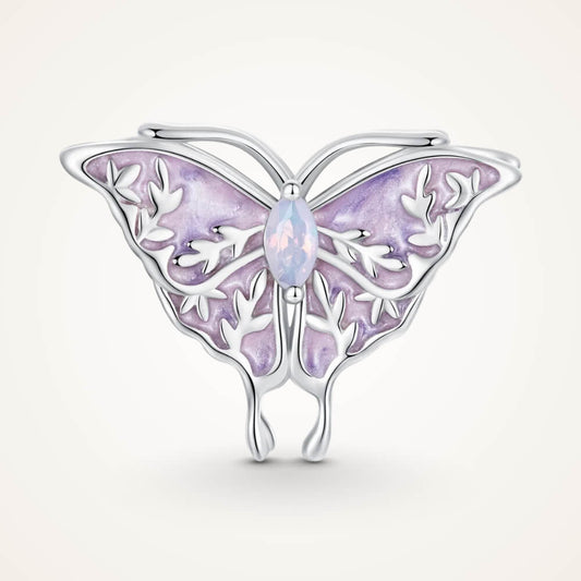 Sterling silver butterfly charm with lavender enamel wings, leaf-shaped filigree details, and an opal-like central gemstone – ORÉYA.