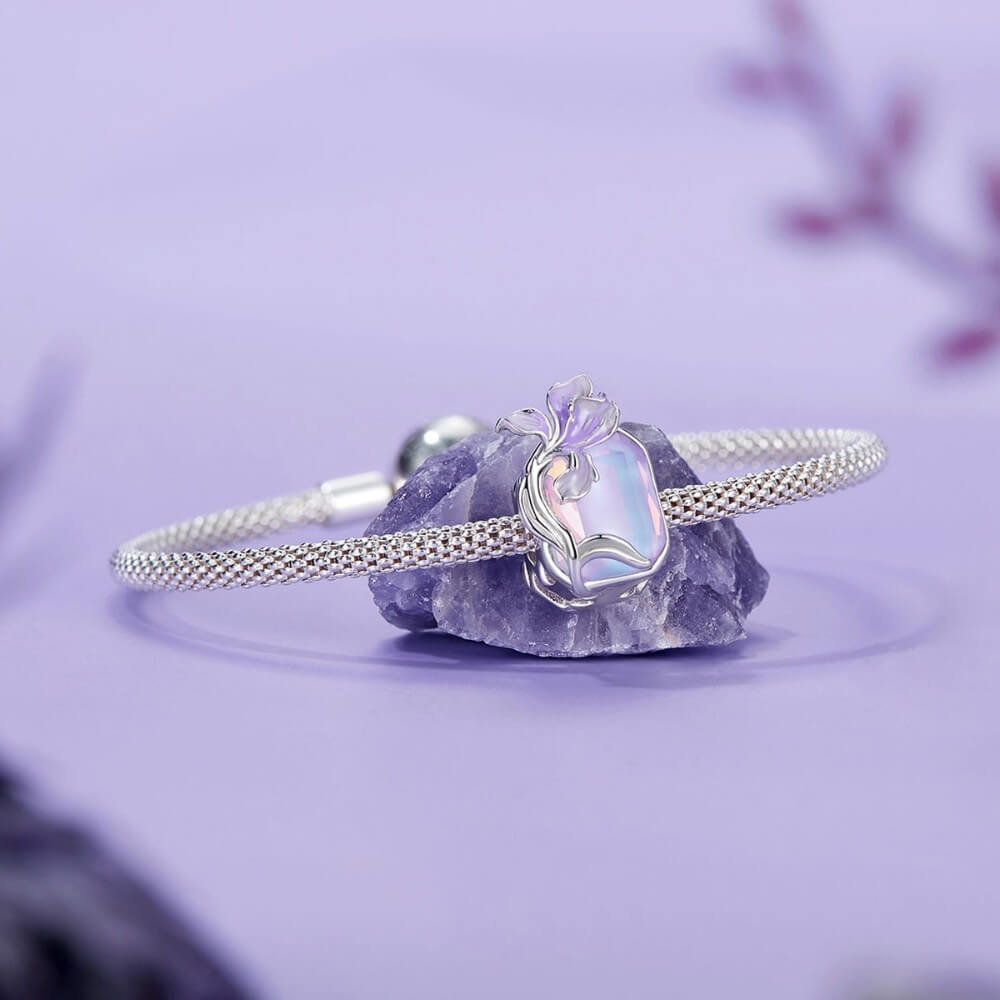Sterling silver crystal charm with lavender flower and iridescent stone.