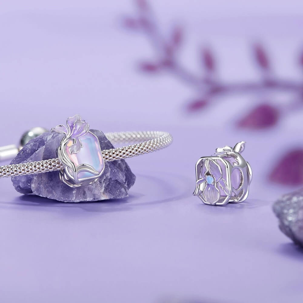 Sterling silver crystal charm with lavender flower and iridescent stone.