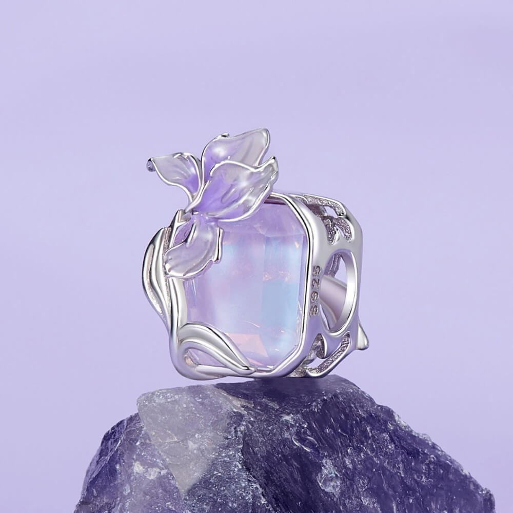 Sterling silver crystal charm with lavender flower and iridescent stone.