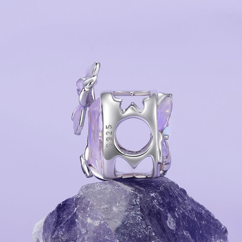 Sterling silver crystal charm with lavender flower and iridescent stone.
