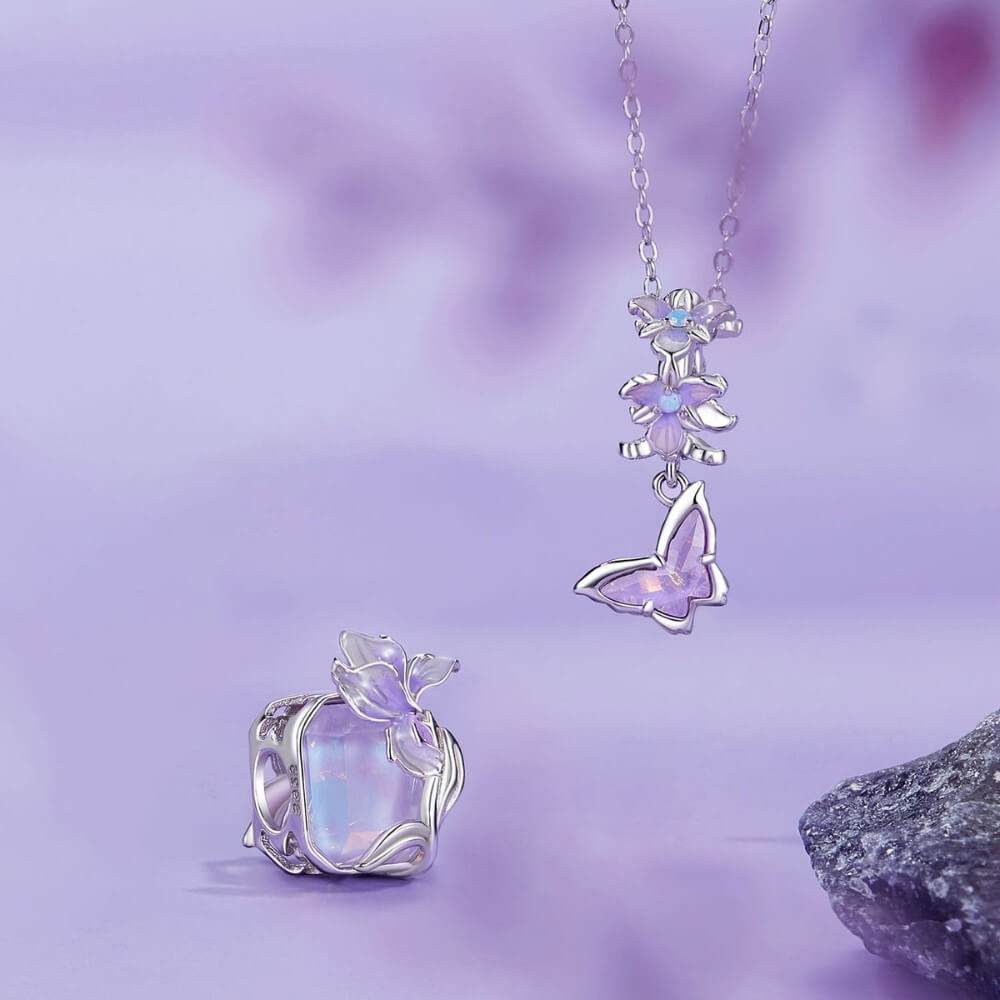 Sterling silver crystal charm with lavender flower and iridescent stone.