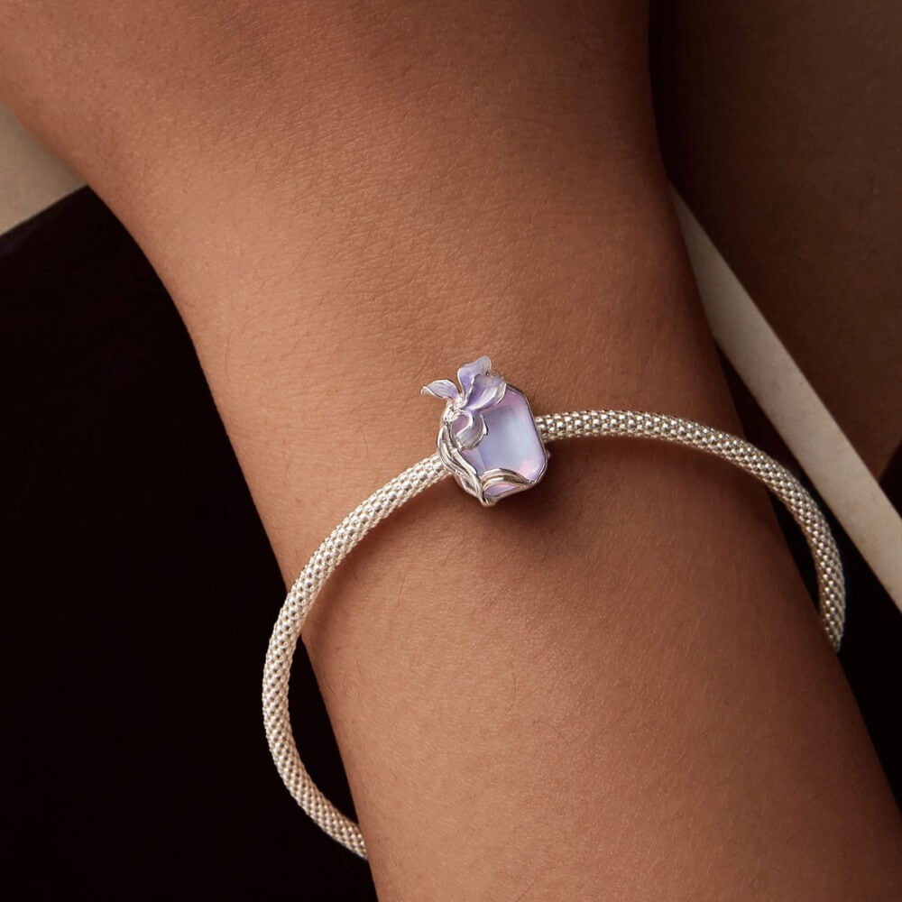 Sterling silver crystal charm with lavender flower and iridescent stone.