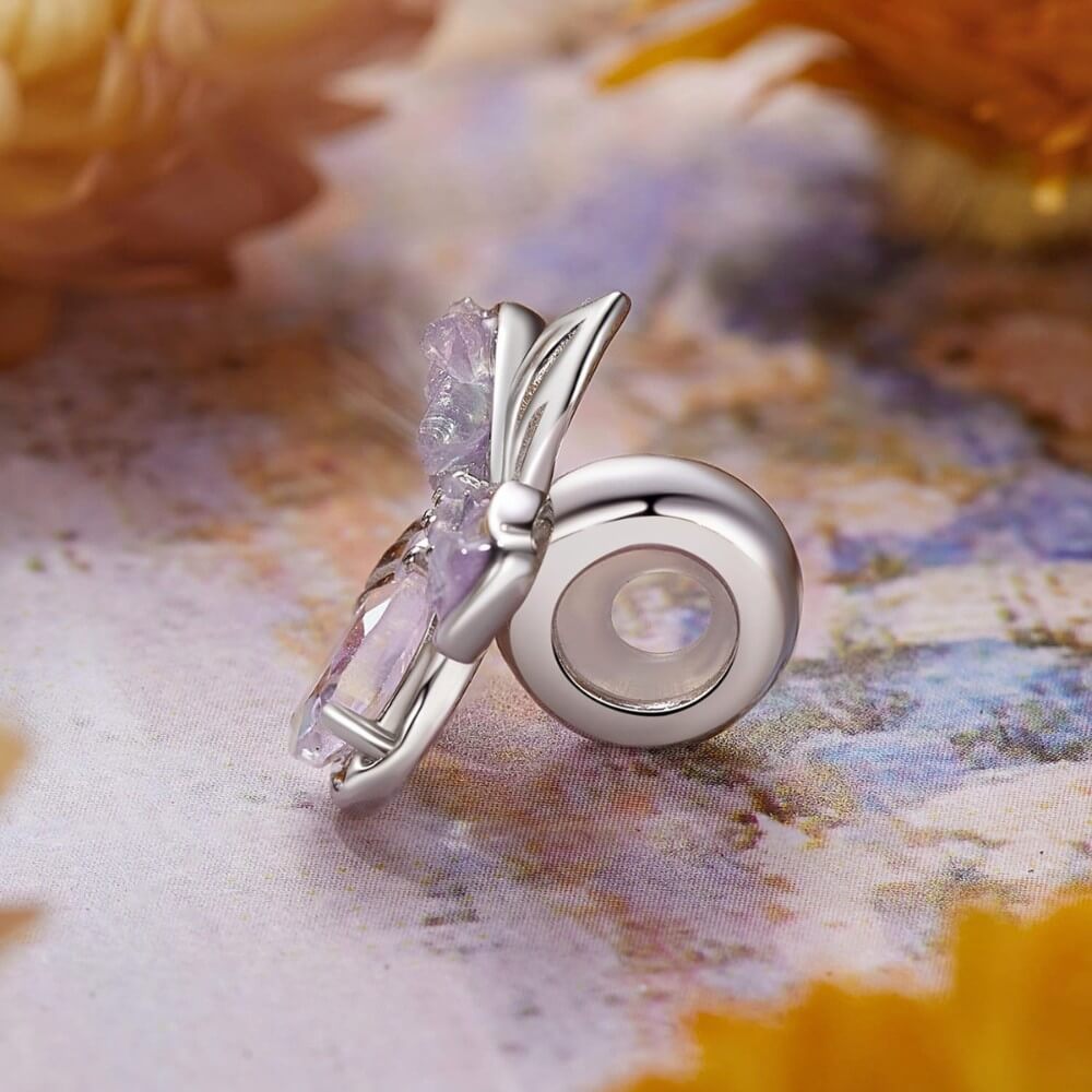 Sterling silver flower charm with lavender petals and iridescent crystal details.