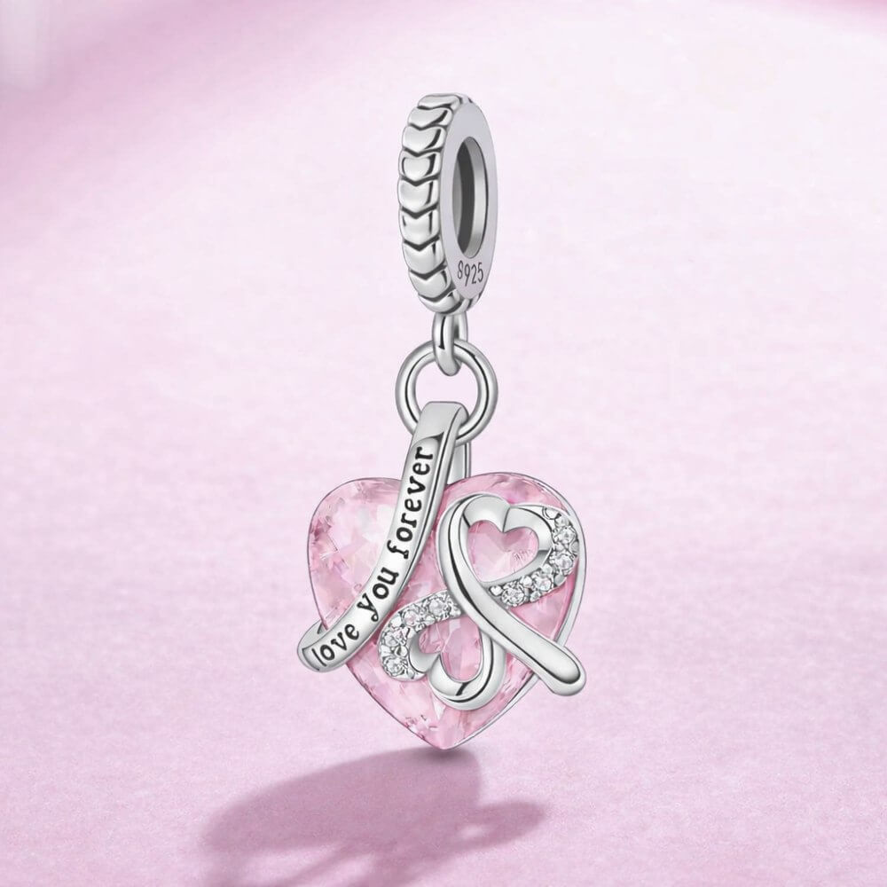 Sterling silver pink heart charm with infinity symbol and love you forever engraving.