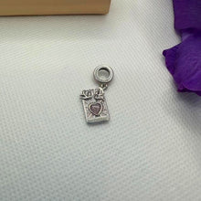 Sterling silver lovers promise charm with pink heart, doves, and engraved message.