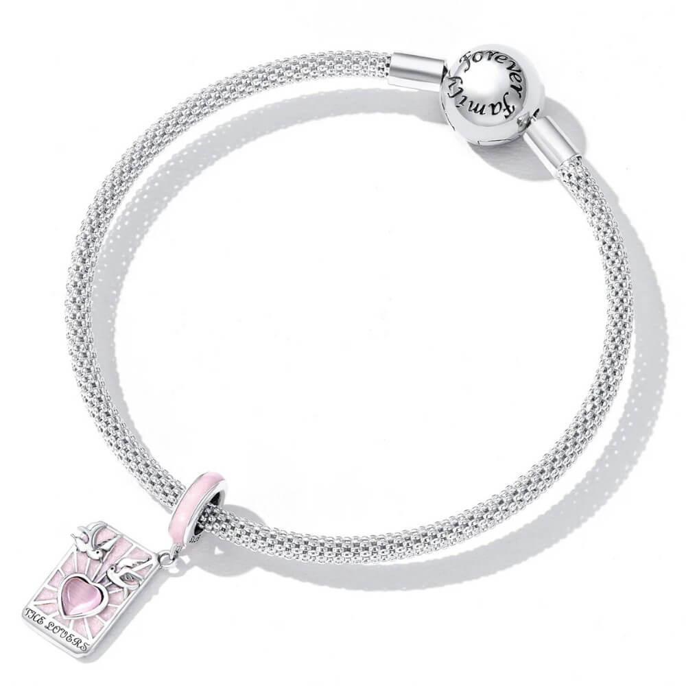 Sterling silver lovers promise charm with pink heart, doves, and engraved message.