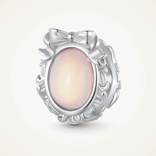 Sterling silver mirror charm with iridescent center and ornate bow frame - ORÉYA