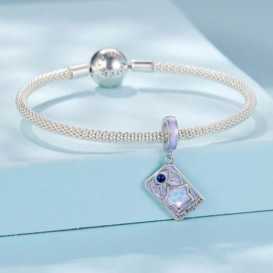 Sterling silver magician tarot charm with lavender enamel and iridescent star.