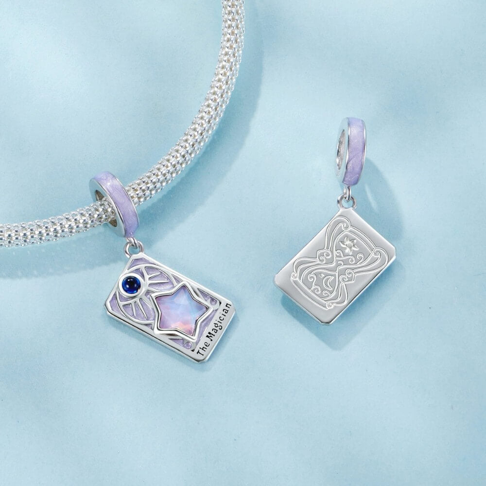 Sterling silver magician tarot charm with lavender enamel and iridescent star.