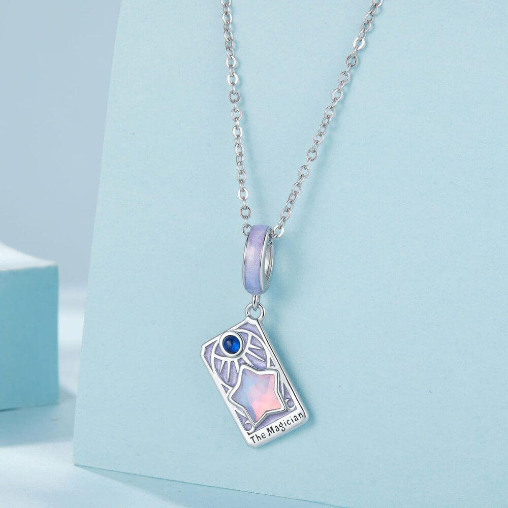 Sterling silver magician tarot charm with lavender enamel and iridescent star.