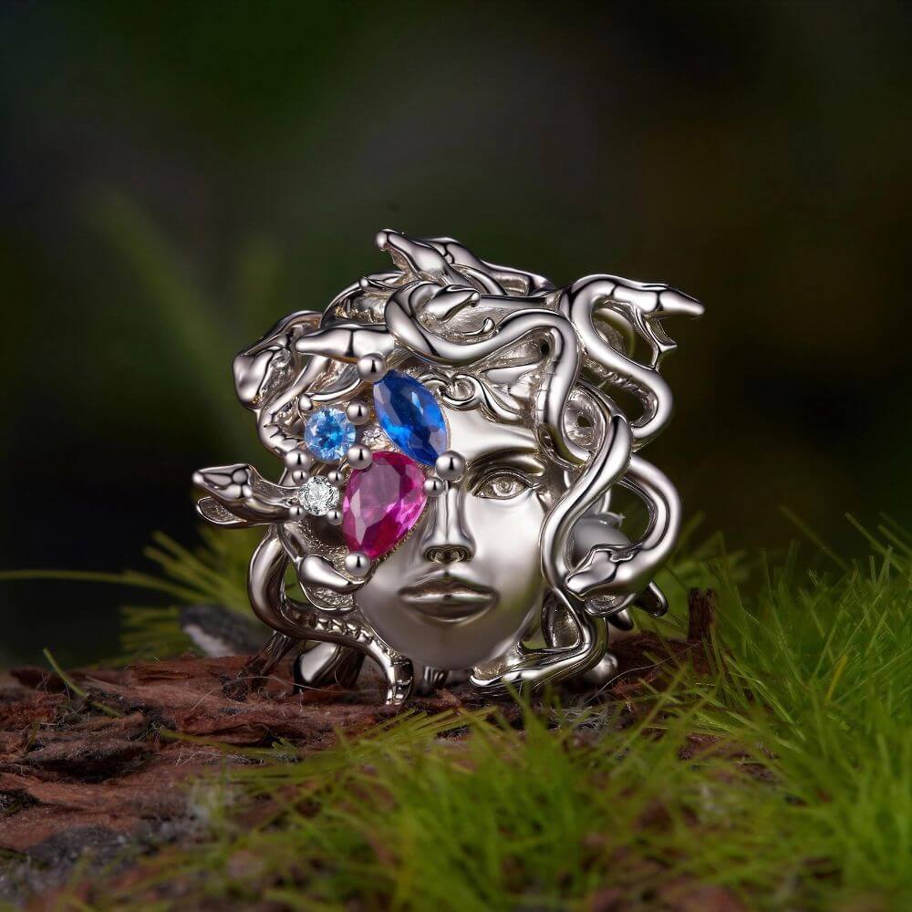 Sterling silver Medusa charm with sculpted snake hair and vivid pink, blue, and clear crystal details.