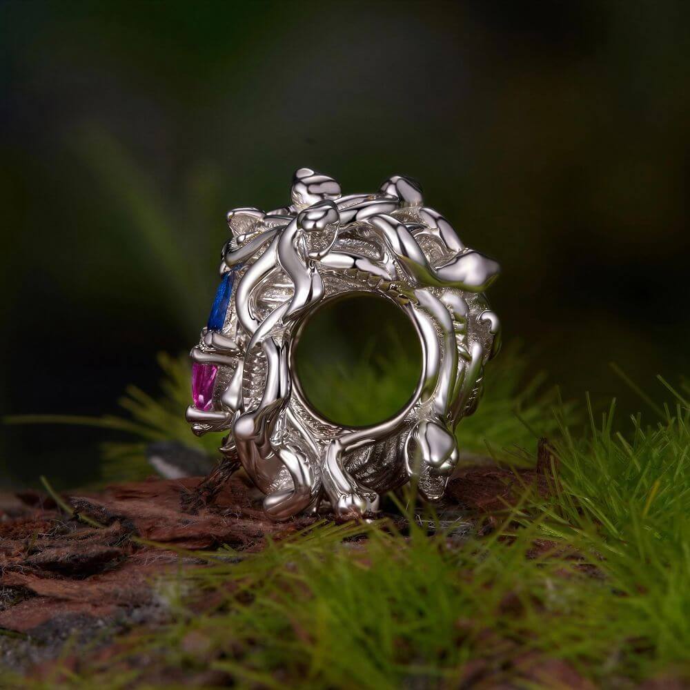 Sterling silver Medusa charm with sculpted snake hair and vivid pink, blue, and clear crystal details.