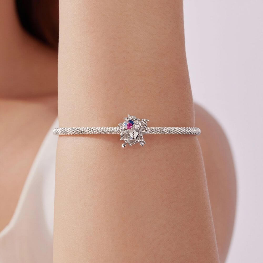 Sterling silver Medusa charm with sculpted snake hair and vivid pink, blue, and clear crystal details.