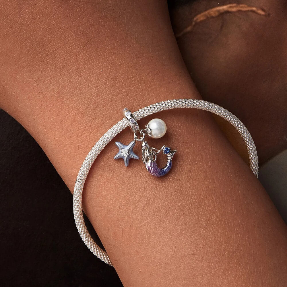 Sterling silver mermaid charm with pearl, starfish, and crystal accents.