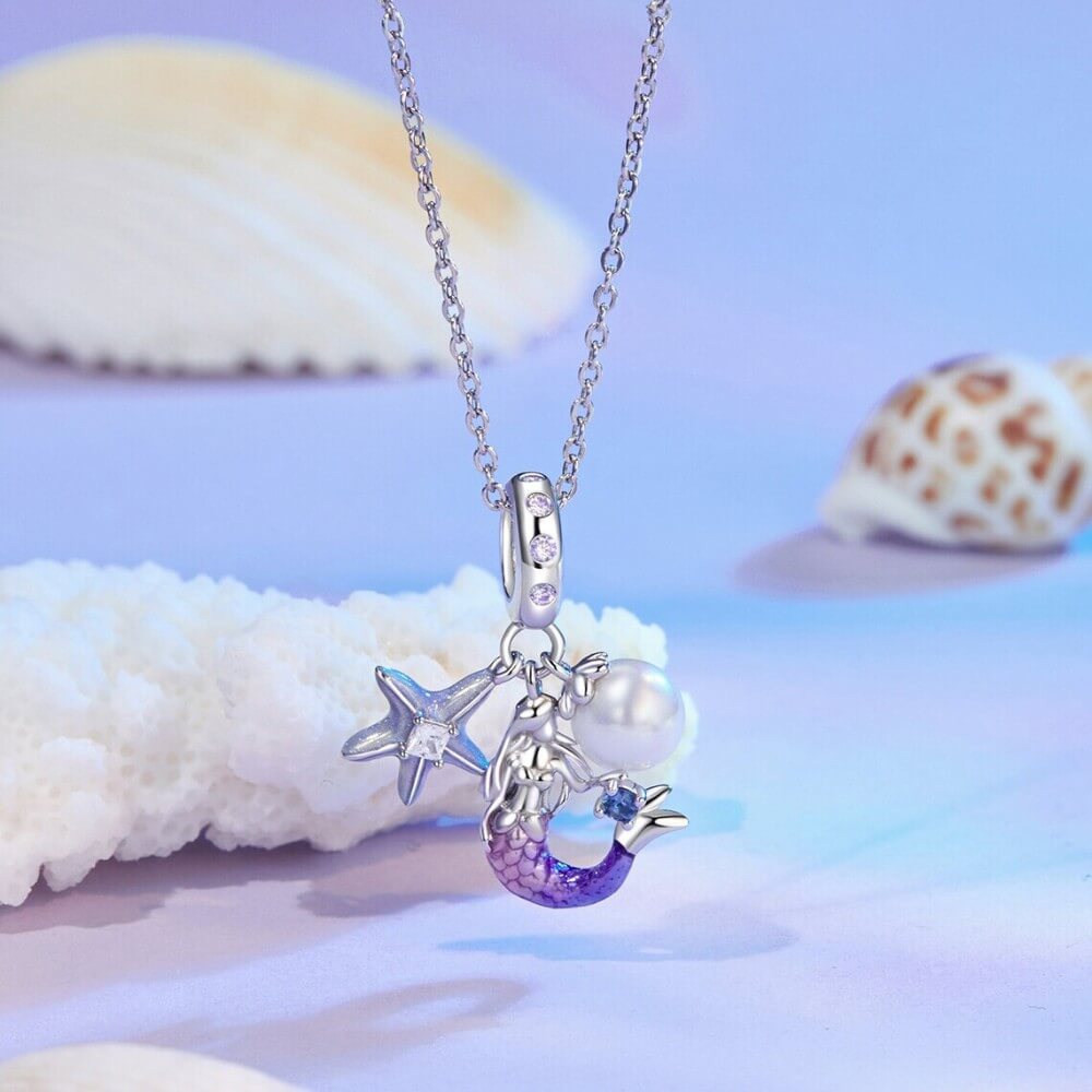 Sterling silver mermaid charm with pearl, starfish, and crystal accents.