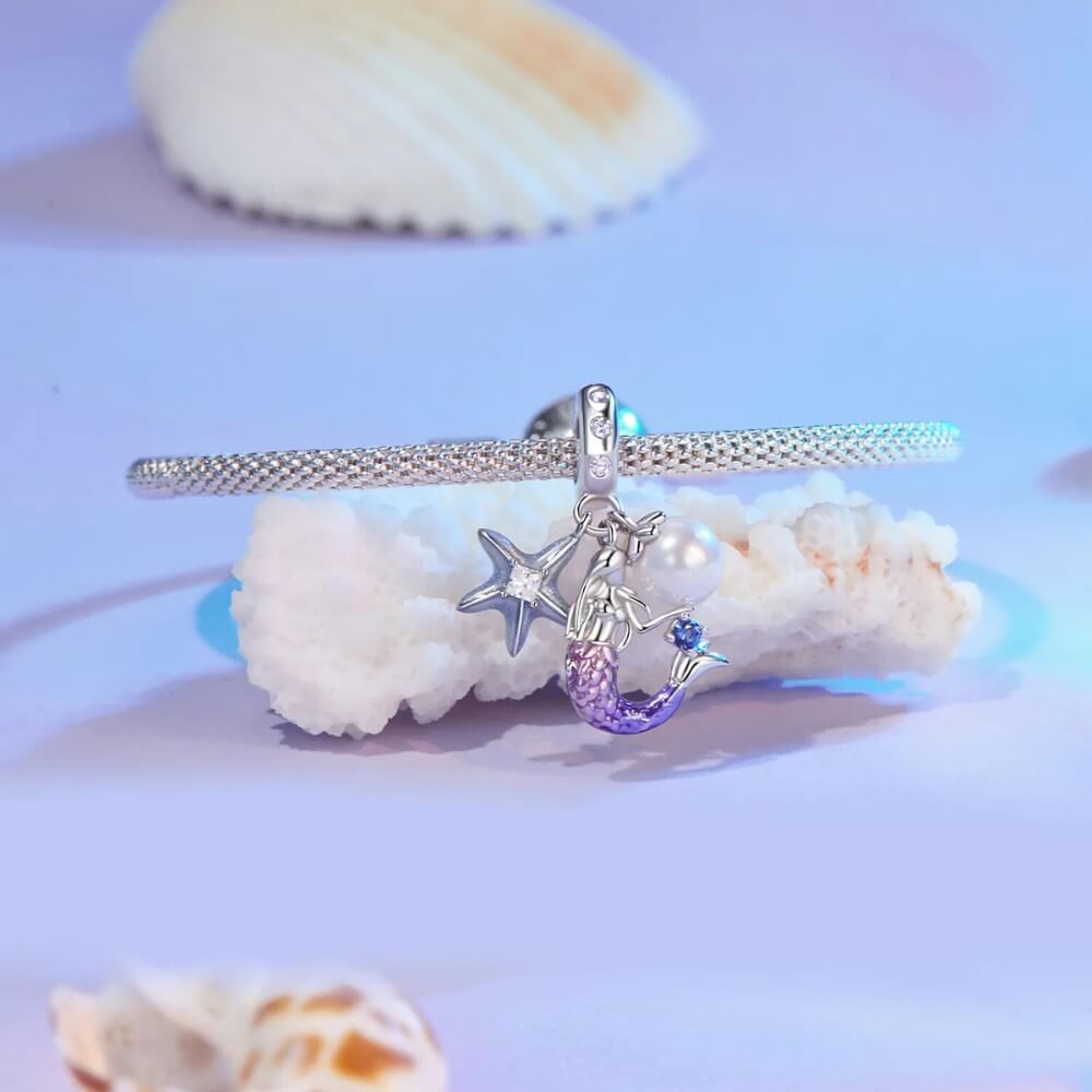 Sterling silver mermaid charm with pearl, starfish, and crystal accents.