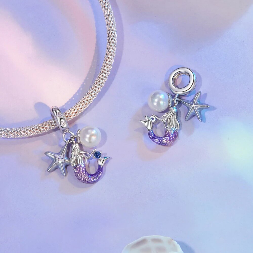 Sterling silver mermaid charm with pearl, starfish, and crystal accents.