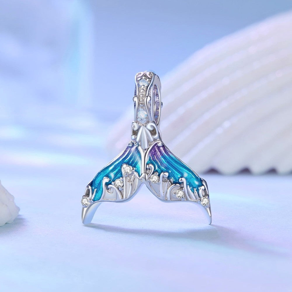 Sterling silver mermaid tail charm with blue purple enamel and crystal details.