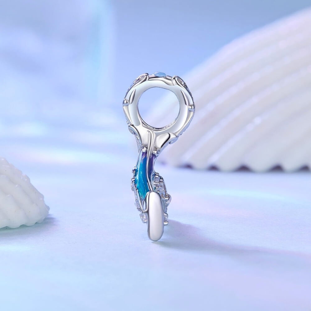Sterling silver mermaid tail charm with blue purple enamel and crystal details.
