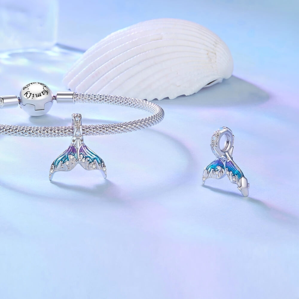 Sterling silver mermaid tail charm with blue purple enamel and crystal details.