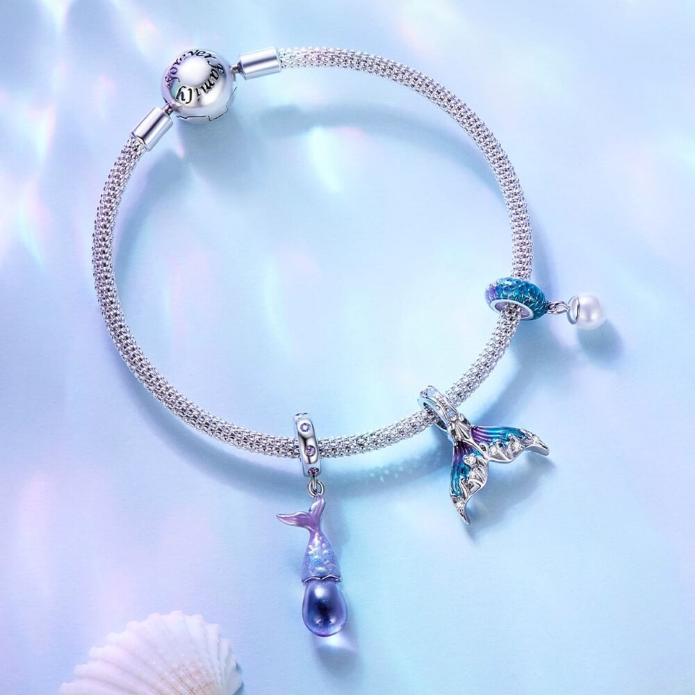 Sterling silver mermaid tail charm with blue purple enamel and crystal details.