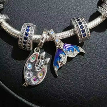 Sterling silver mermaid tail charm with blue purple enamel and crystal details.