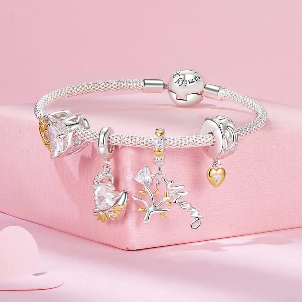 Sterling silver mom angel charm with heart crystal and gold lettering.