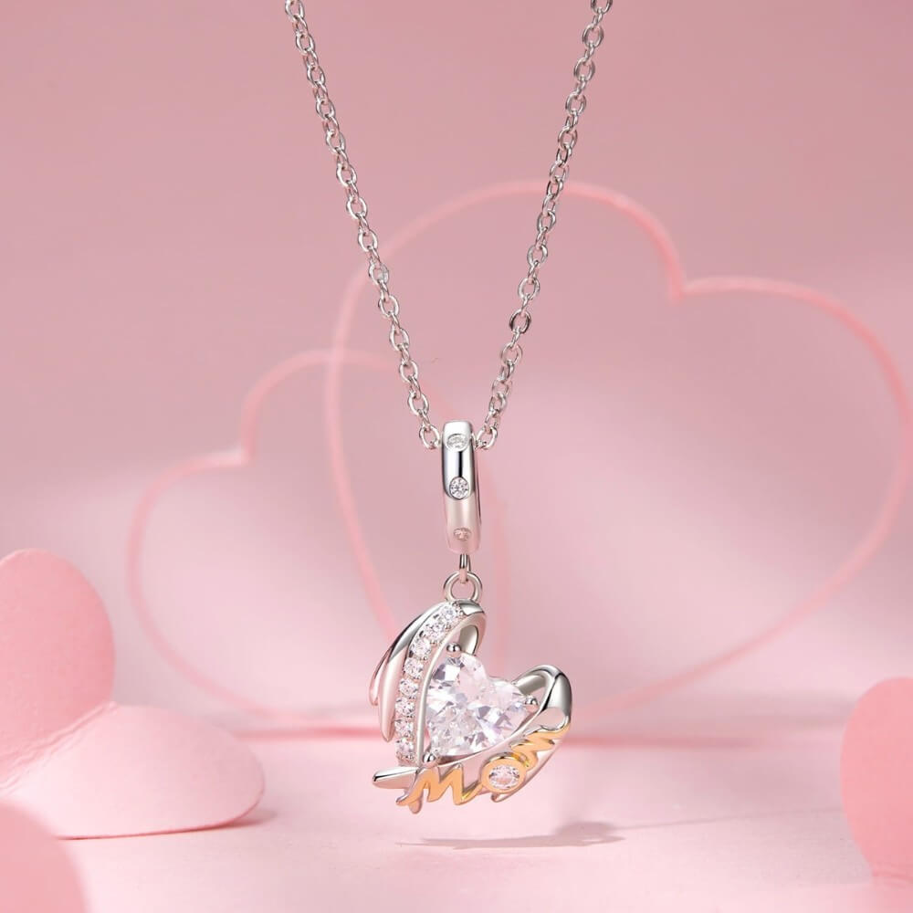 Sterling silver mom angel charm with heart crystal and gold lettering.