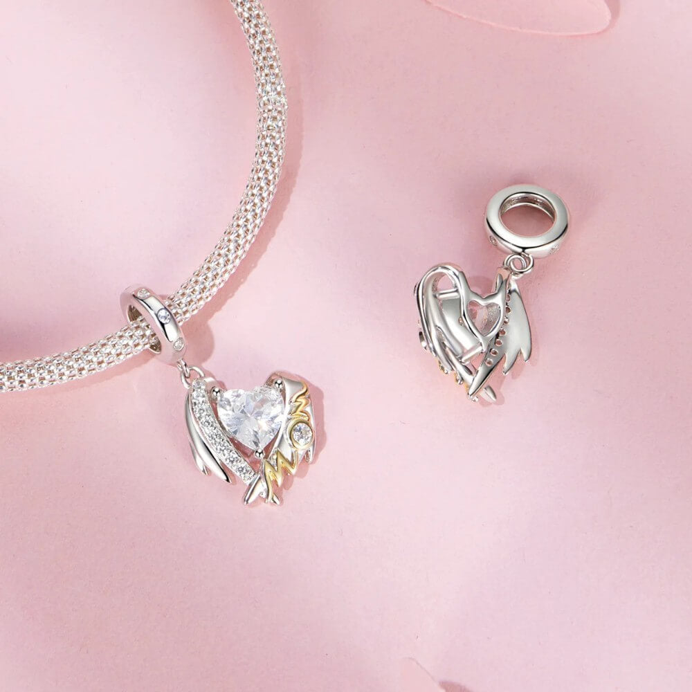 Sterling silver mom angel charm with heart crystal and gold lettering.