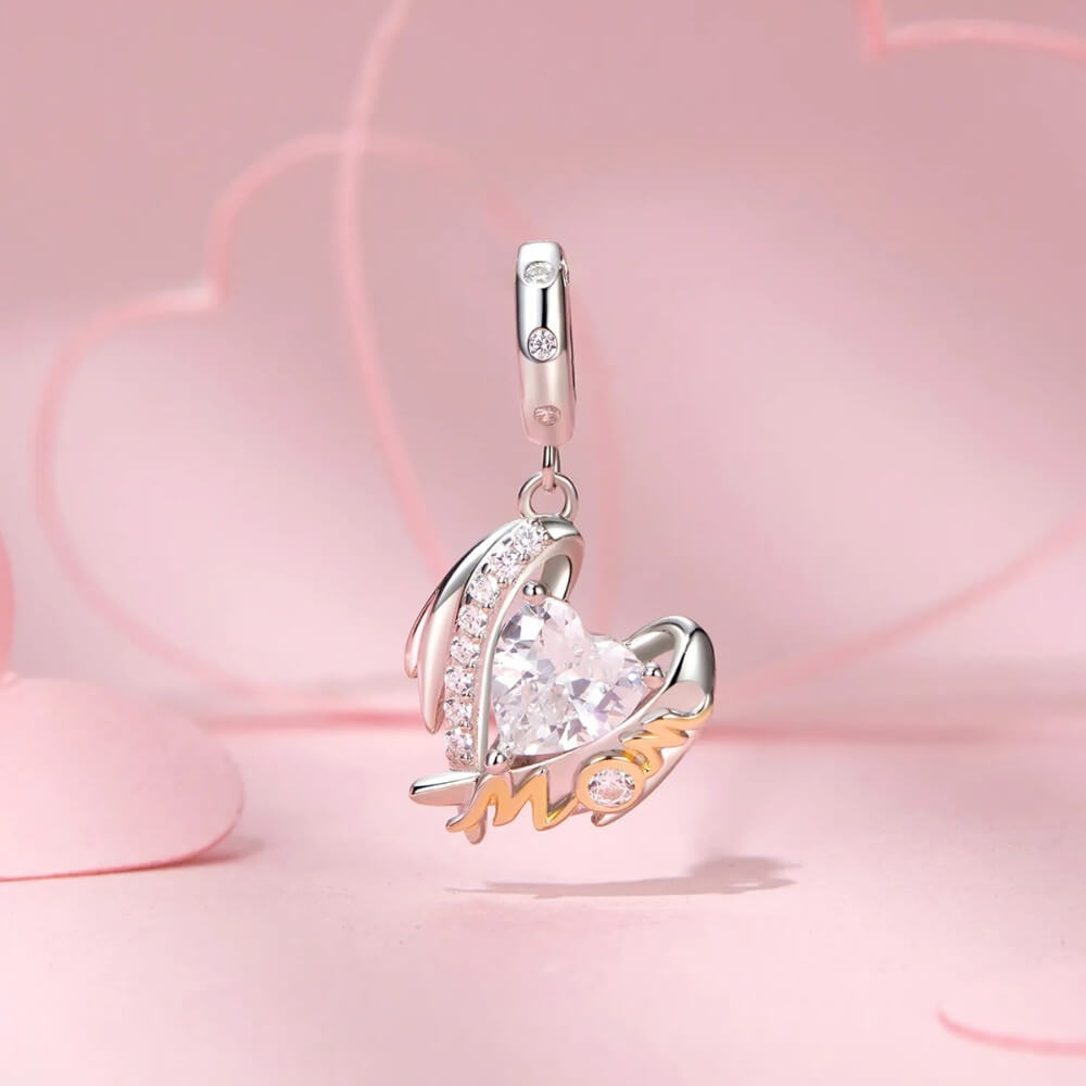 Sterling silver mom angel charm with heart crystal and gold lettering.